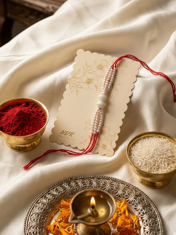NVR White Pearls & Red Thread Rakhi with Roli Chawal Chandan Mishri