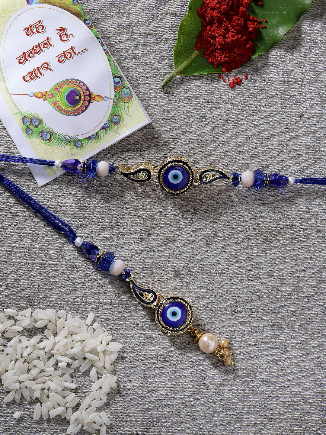 NVR Unisex Set of 2 Blue Evil Eye Beaded Bhaiya Bhabhi Rakhi With Roli Chawal & Chocolate