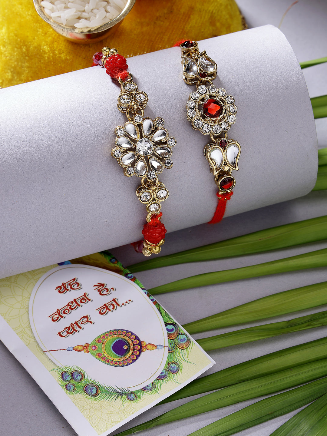 NVR Men Set of 2 Gold-Toned Stone-Studded Rakhi With Roli Chawal & Chocolate