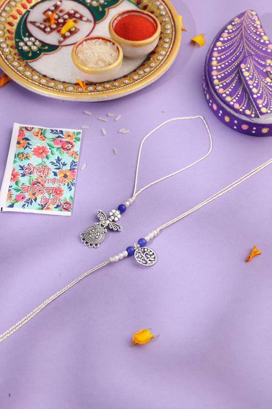 NVR Set of 2 Silver Toned Pearls & Beads Bhaiya Bhabhi Rakhi with Roli Chawal Chandan & Mishri