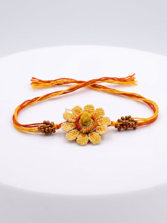 NVR Yellow Floral Seed Thread Rakhi with Roli Chawal Chandan Mishri