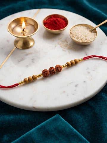 NVR Religious Rudraksh & Red Thread Rakhi with Roli Chawal Chandan Mishri