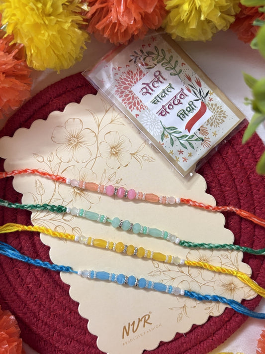 NVR Set of 4 Multicolor Artificial Beads Thread Rakhi with Roli Chawal Chandan Mishri