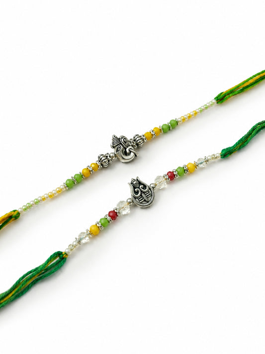 NVR Set of 2 Multicolor Religious Thread Rakhi with Roli Chawal Chandan Mishri