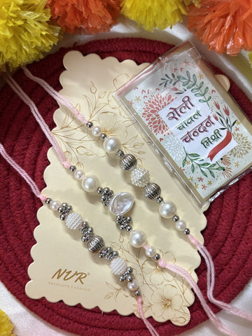 NVR Set of 3 White Pearls Thread Rakhi with Roli Chawal Chandan Mishri
