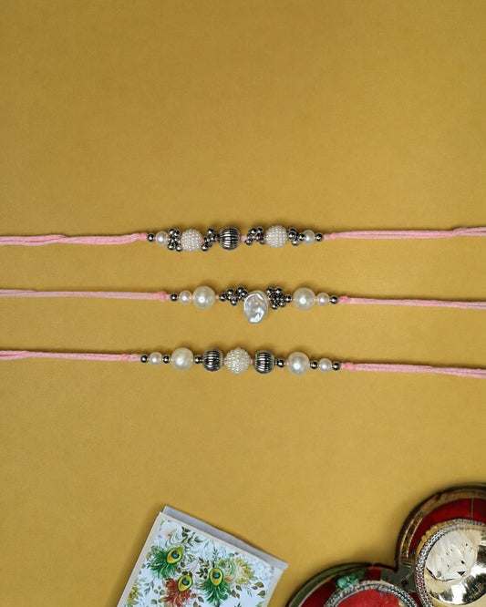 NVR Set of 3 White Pearls Thread Rakhi with Roli Chawal Chandan Mishri