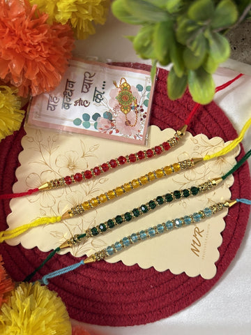 NVR Set of 4 Multicolor Artificial Beads Thread Rakhi with Roli Chawal Chandan Mishri